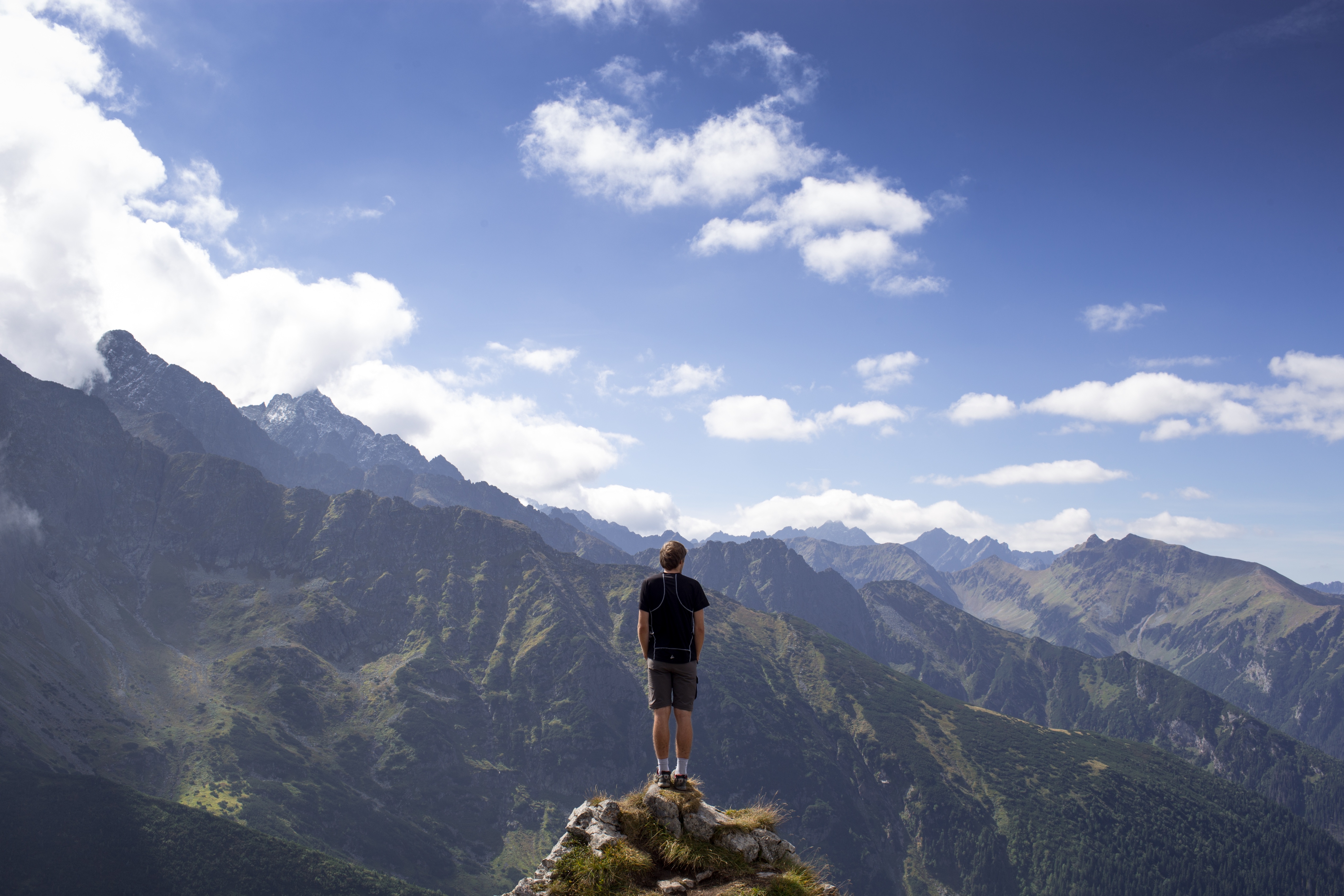Picture of a man standing in front of a vast landscape.
